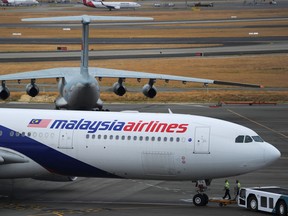 A Malaysia Airlines plane prepares to go out onto the runway