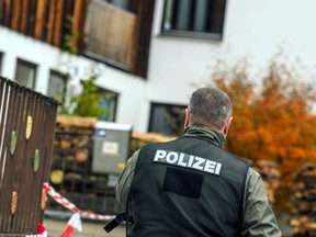 A policeman is pictured on October 19, 2016 in Georgensgmuend, southern Germany, in front of a house of a member of the so-called Reichsbuerger movement.