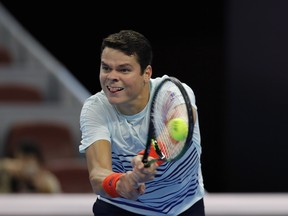 Milos Raonic of Canada returns a shot against Florian Mayer of Germany during the Men's singles first round match on day four of the 2016 China Open at the China National Tennis Centre on October 4, 2016 in Beijing, China.