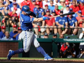 Josh Donaldson of the Toronto Blue Jays hits a double to left field to score Ezequiel Carrera #3 against Cole Hamels #35 of the Texas Rangers during the third inning in game one of the American League Divison Series at Globe Life Park in Arlington on October 6, 2016 in Arlington, Texas.