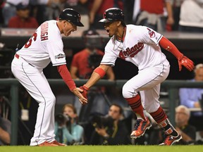 Francisco Lindor of the Indians celebrates with third base coach Mike Sarbaugh after hitting a solo home run in the third inning against the Boston Red Sox during Game 1 of the American League Division Series at Progressive Field in Cleveland on Thursday night.