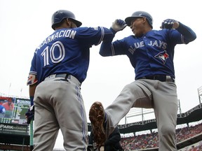 Ezequiel Carrera #3 of the Toronto Blue Jays celebrates with Edwin Encarnacion #10 after hitting a solo home run against the Texas Rangers in the fifth inning of game two of the American League Divison Series at Globe Life Park in Arlington on October 7, 2016 in Arlington, Texas.
