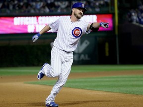 Travis Wood of the Cubs celebrates after hitting a home run in the fourth inning against the San Francisco Giants at Wrigley Field in Chicago on Saturday night.