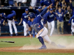 Toronto's Josh Donaldson celebrates after scoring the winning run against Texas on Oct. 9.