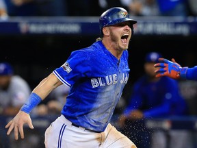 Josh Donaldson celebrates after scoring the winning run against the Texas Rangers in Game 3 of the ALDS on Oct. 9.