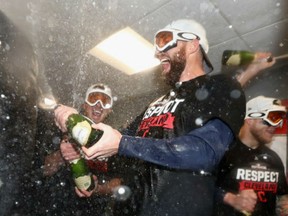 Jason Kipnis of the Cleveland Indians celebrates with teammates in the clubhouse after defeating the Boston Red Sox 4-3 in game three of the American League Divison Series to advance to the American League Championship Series at Fenway Park on Monday night  in Boston.