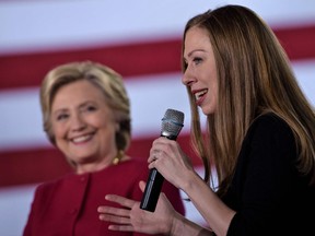 Democratic presidential nominee Hillary Clinton listens as her daughter Chelsea Clinton speaks during a town hall meeting October 4, 2016 in Haverford, Pennsylvania