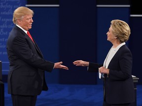 U.S. Democratic presidential candidate Hillary Clinton and US Republican presidential candidate Donald Trump shakes hands after the second presidential debate at Washington University in St. Louis, Mo., on Oct. 9.