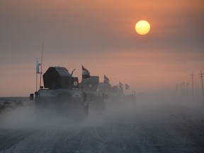 Pro-government forces drive in military vehicles in Iraq's eastern Salaheddin province, south of Hawijah, on October 10, 2016, as they clear the area in preparation for the push to retake the northern Iraqi city of Mosul. Recently, ISIL has tried to use small drones to launch attacks in Iraq.