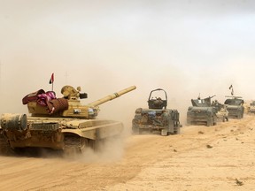 Iraqi forces deploy on October 17, 2016 in the area of al-Shurah, some 45 kms south of Mosul