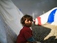 A displaced Iraqi girl looks on upon arriving to a refugee camp on October 22, 2016 in the town of Qayyarah, south of Mosul, as an operation to recapture the city of Mosul from the Islamic State group takes place.