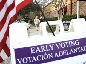 A voter arrives at an Osceola County polling station to cast her ballot during early voting in the federal election, in Kissimee, Florida on October 25, 2016.