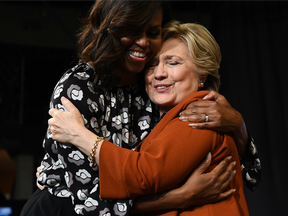 US First Lady Michelle Obama embraces Democratic presidential nominee Hillary Clinton during a campaign rally in Winston-Salem, North Carolina on October 27, 2016.