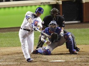 Miguel Montero of the Cubs hits a grand slam homer during the eighth inning of Game 1 of the National League championship series against the Los Angeles Dodgers on Saturday night in Chicago. The Cubs won 8-4.