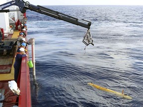 In this Monday, April 14, 2014, an autonomous underwater vehicle is deployed from ADV Ocean Shield in the search of the missing Malaysia Airlines Flight 370