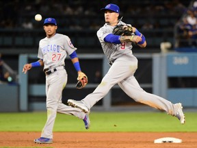 Second baseman Javier Baez of the Chicago Cubs makes an acrobatic throw to record an out during Game 5 action in the NLCS Thursday in Los Angeles. The Cubs won 8-4 to take a 3-2 lead in the series.