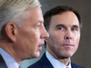 Finance Minister Bill Morneau, right, watches as Chairman of the Advisory Council Dominic Barton speaks at a news conference in Ottawa, Thursday, Oct. 20, 2016.