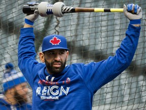 Toronto Blue Jays' Jose Bautista stretches before taking batting practice Thursday in Cleveland. The Jays take on the Indians in the best-of-seven ALCS with the winner advancing to the World Series.