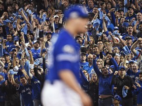 Toronto Blue Jays fans celebrate after Blue Jays pitcher Roberto Osuna struck out Baltimore Orioles' Matt Wieters during ninth inning American League wild-card game action in Toronto, Tuesday, Oct.4, 2016.