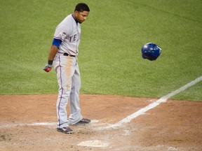 Texas Rangers shortstop Elvis Andrus slams his helmet after striking out in the eighth inning against the Toronto Blue Jays in Game 5 of the ALDS on Oct. 14, 2015.