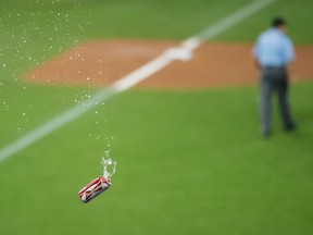 In this Oct. 14, 2015 file photo, a beer is thrown onto the field in Toronto during game five of the AL Division Series.