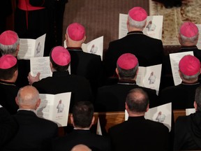 Bishops hold a paper bearing a photo of Pope Francis during his meeting with the Assyro-Chaldean community in the Chaldean catholic church of St. Simon Bar Sabbae in Tbilisi, Georgia, on Sept. 30.