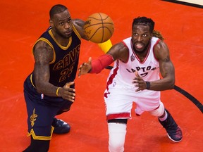 Cleveland's LeBron James (left) battles Toronto's DeMarre Carroll for a loose ball during playoff action in May 2016.