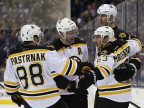 Boston Bruins' Brad Marchand, front right, celebrates his goal against the Columbus Blue Jackets with teammates David Pastrnak, David Backes and Zdeno Chara during the third period Thursday, Oct. 13, 2016.