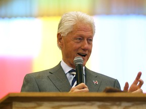 Former President Bill Clinton visits Grace Emmanuel Baptist Church during an unannounced campaign stop for his wife, presidential nominee Hillary Clinton on Sunday — how he would be titled as a presidential spouse is just one of many questions about what his role will be if she becomes president.