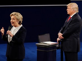 Republican presidential nominee Donald Trump (right) listens to Democratic presidential nominee Hillary Clinton during the second presidential debate in St. Louis on Oct. 9.