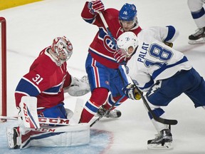 Montreal Canadiens' goalie Carey Price makes a game-saving save off Tampa Bay Lightning Ondrej Palat from close in during NHL action Thursday night in Montreal. Defenceman Nathan Beaulieu tries to impede Palat. The Canadiens were 3-1 winners, extending their win streak to six straight games.