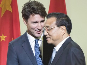 Canadian Prime Minister Justin Trudeau, left, introduces Chinese Premier Li Keqiang after speaking to a business luncheon, Friday, September 23, 2016 in Montreal.