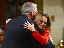 International Trade Minister Chrystia Freeland embraces former minister of international trade Ed Fast in the House of Commons on Monday, Oct. 31, 2016 to celebrate the signing of the CETA deal.