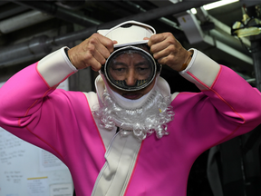 Diver Philip Chan dressed as Santa to entertain visitors during December 2014.