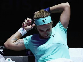 Svetlana Kuznetsova of Russia cuts her hair in her singles match against Agnieszka Radwanska of Poland during the BNP Paribas WTA Finals in Singapore Monday.