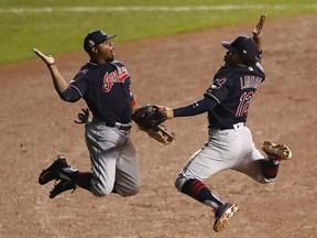 Rajai Davis, left, and Francisco Lindor of the Cleveland Indians exchange high-fives following their 1-0 victory over the Chicago Cubs in Game 3 of the World Series Friday at Wrigley Field in Chicago. The Indians lead the series 2-1.