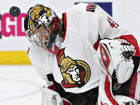 Ottawa Seantors' goaltender Craig Anderson takes a shot on the top of the helmet during NHL action Sunday night in Edmonton. Anderson recorded a 2-0 shutout in his first start since leaving the team to be with his cancer-stricken wife. He returned to the team at his wife's behest when the backup Andrew Hammond was injured last week.