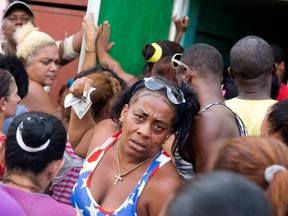 Cubans jam into a store Sunday to buy food in preparation for the arrival of Hurricane Matthew