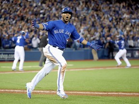 Edwin Encarnacion of the Toronto Blue Jays reacts after hitting a three-run walk-off home run in the eleventh inning to defeat the Baltimore Orioles 5-2 in the American League Wild Card game at Rogers Centre on October 4, 2016.