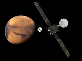 In this artist impression provided by the European Space Agency, ESA, the  ExoMars Trace Gas Orbiter, TGO, right, and its entry, descent and landing demonstrator module, Schiaparelli, center, approaching Mars. The separation was scheduled to occur on Sunday Oct. 16, about seven months after launch. One of the NASA scientists involed in Mars research and swept up in raids last year in Turkey remains in prison.