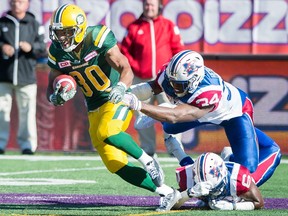 Edmonton's John White (left) breaks away from two Montreal defenders on Oct. 10.