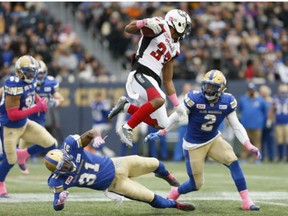 Ottawa Redblacks running back Mossis Madu Jr. leaps over Winnipeg Blue Bombers cornerback Maurice Leggett on Oct. 29.