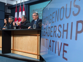 Liberal MP for Northwest Territories, Michael McLeod, right, and members of the Indigenous Leadership Initiative listen to advisor Miles Richardson speak during a news conference in Ottawa, Monday Oct. 3, 2016.