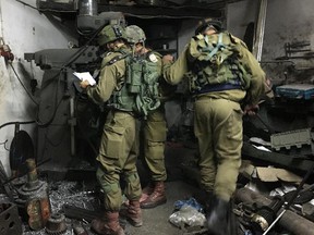 Israeli forces raid a metal-working shop they say was used to manufacture crude submachine guns in the Palestinian town of Azzun in the Israeli-occupied West Bank early on the morning of Oct. 10, 2016.