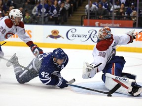 Tyler Bozak (centre) has his sprawling shot denied by Montreal Canadiens goaltender Mike Condon (right) during pre-season play in Toronto on Oct. 2.