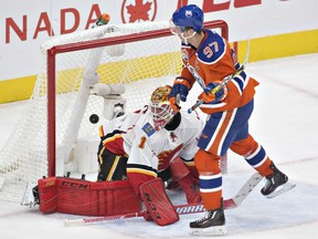 Calgary Flames' goalie Brian Elliott is scored on by the Oilers' Connor McDavid during second period NHL action in Edmonton on Wednesday night.