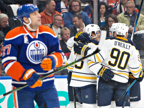 Milan Lucic (left) skates by as Buffalo celebrates a first-period goal on Oct. 16.