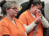 Brenda Frye, 52 looks down as her daughter Heather Frye wipes away tears as the pair appear for sentencing in Summit County Common Pleas Judge Lynne Callahan's court on Wednesday, Oct. 12, 2016, in Akron, Ohio.