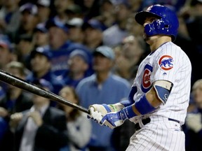 Javier Baez of the Chicago Cubs follows through on his game-winning homerun in the eighth inning of Friday's Game 1 of the NLDS against the San Francisco Giants at Wrigley Field. The Cubs were 1-0 winners behind lefthander Jon Lester.