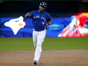 Edwin Encarnacion rounds the bases after homering in the first inning against the Texas Rangers on Oct. 9.